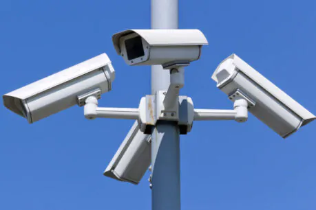 Four security cameras on blue sky